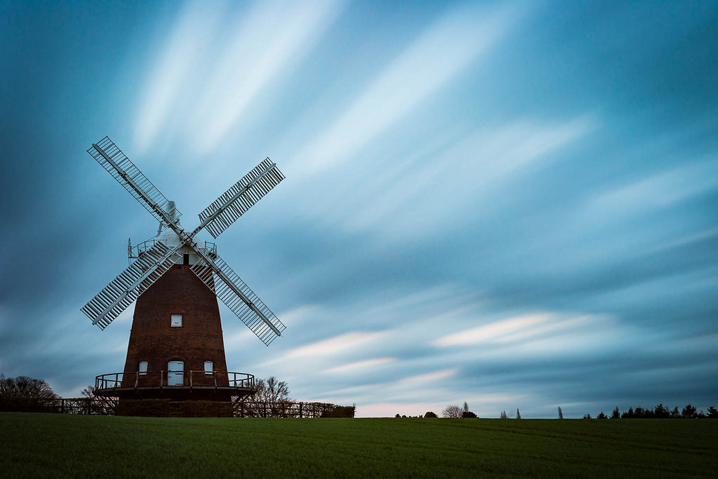 windmill against racing clouds