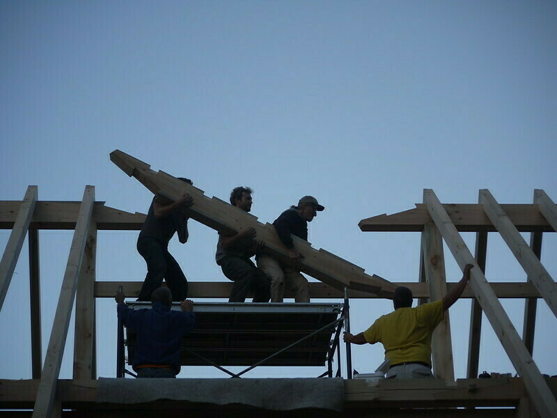 men raising a barn